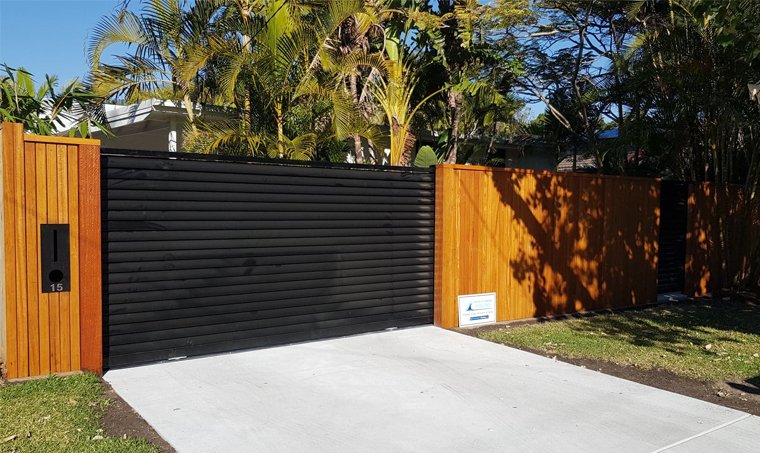 Automatic gate cost in Perth for a black sliding gate with timber panels by Gate Master Australia